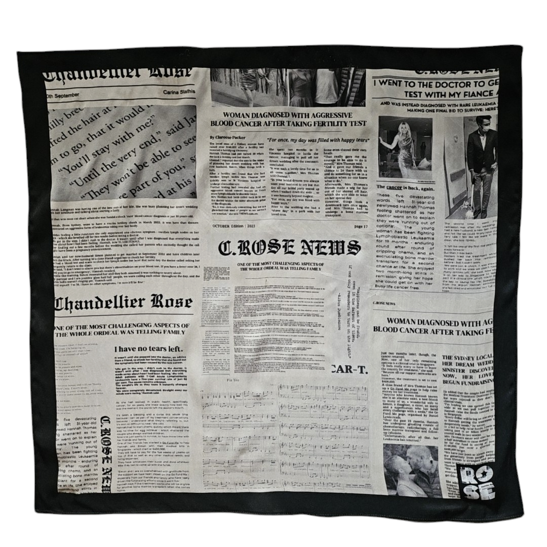 A newspaper scarf with black and white text patterns, tied in a knot.